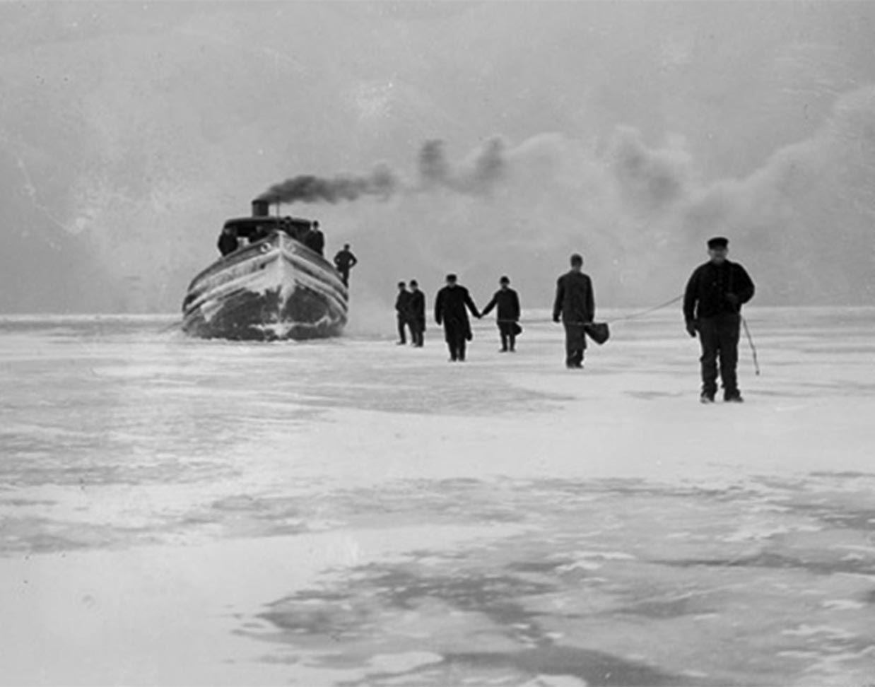 Image of men walking on the partially frozen ice of Lake Michigan, with a steamship or tugboat in the background in Chicago, Illinois. DN-0001833, Chicago Daily News negatives collection, Chicago History Museum.